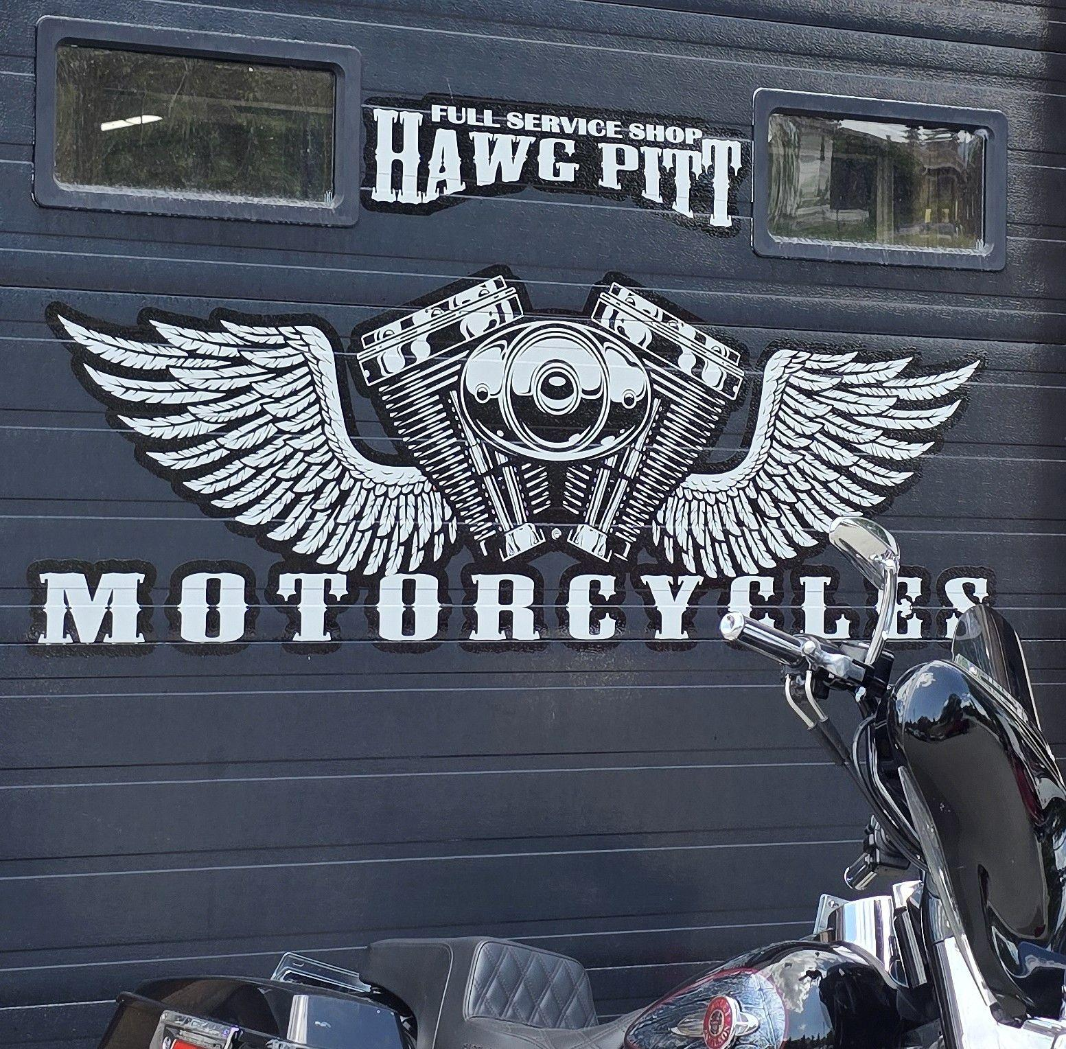 Hawg Pitt Motorcycles branded wall with winged engine logo
