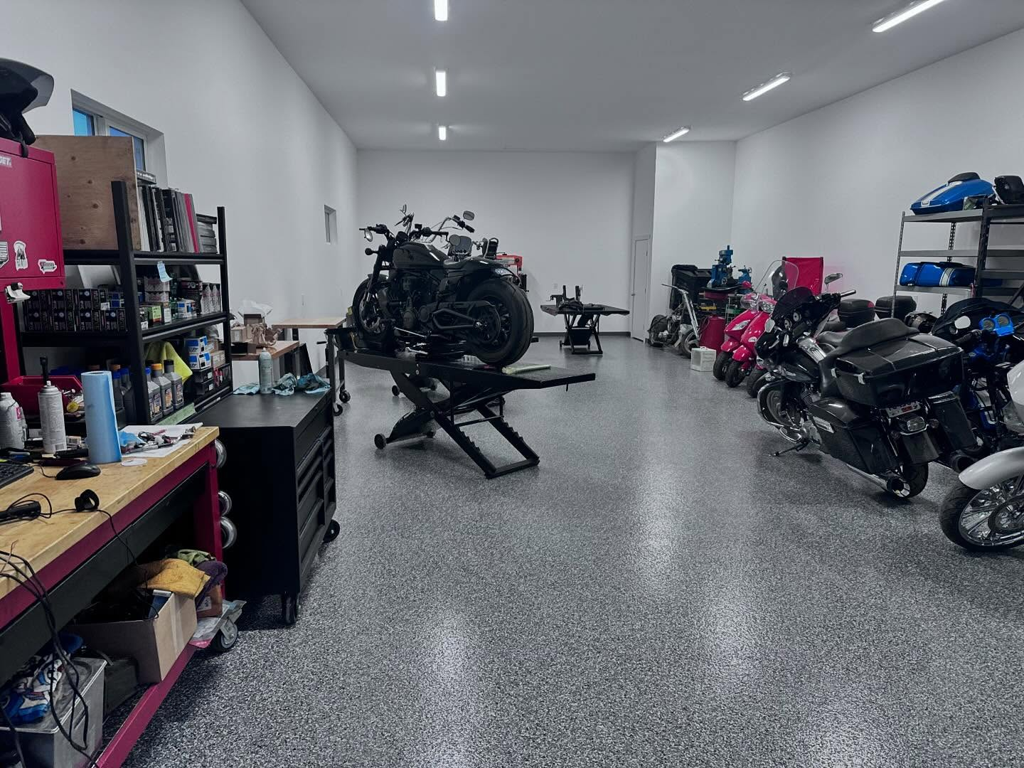 Professional service bay with motorcycles and diagnostic equipment