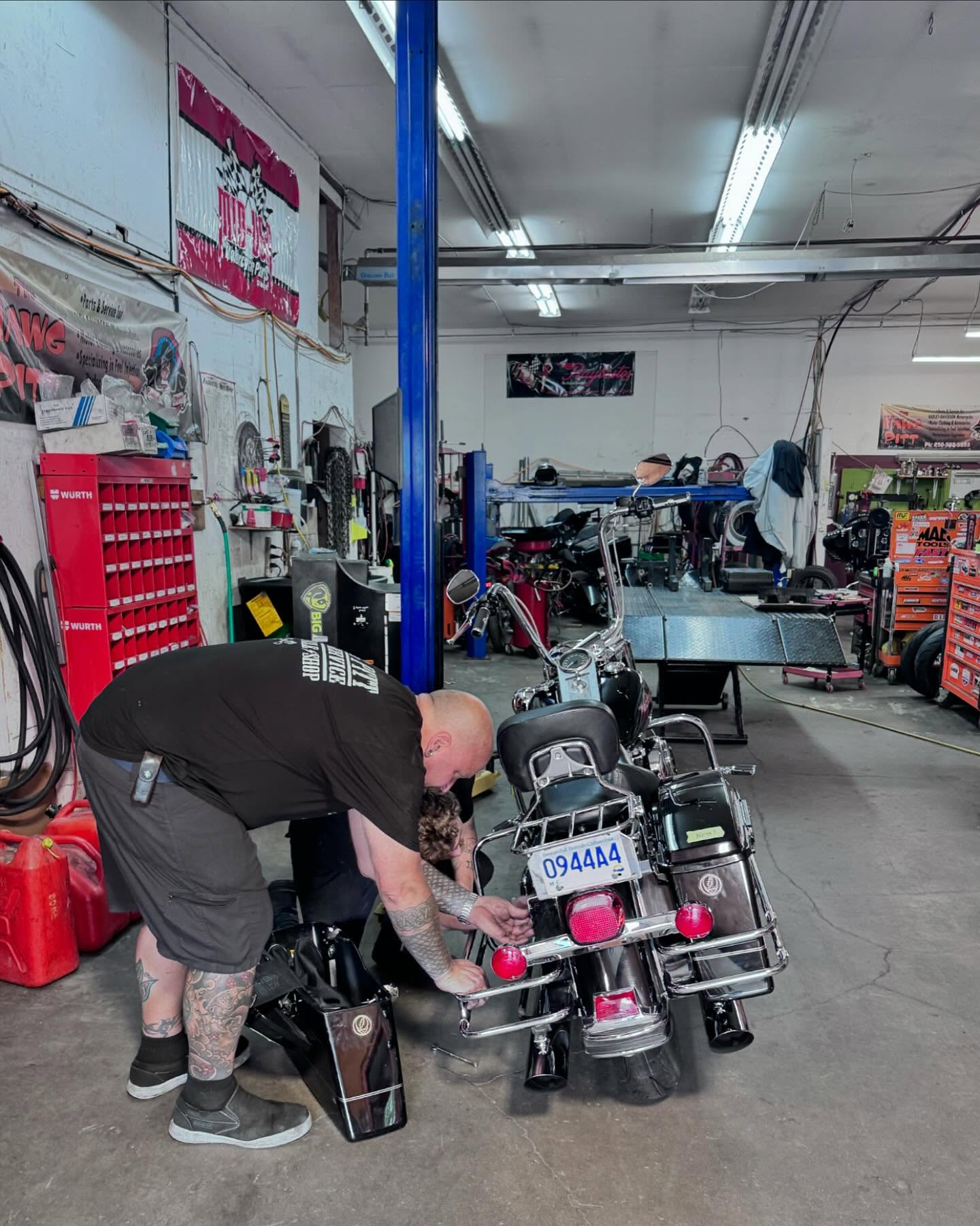 Technician performing detailed motorcycle service work