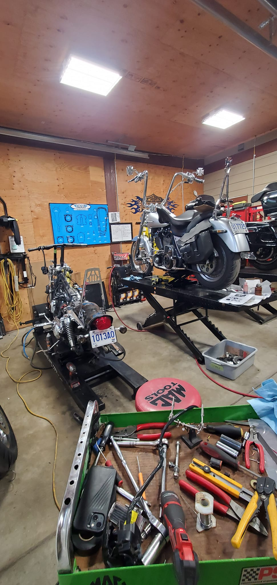 Workshop with motorcycles on lifts and professional tools